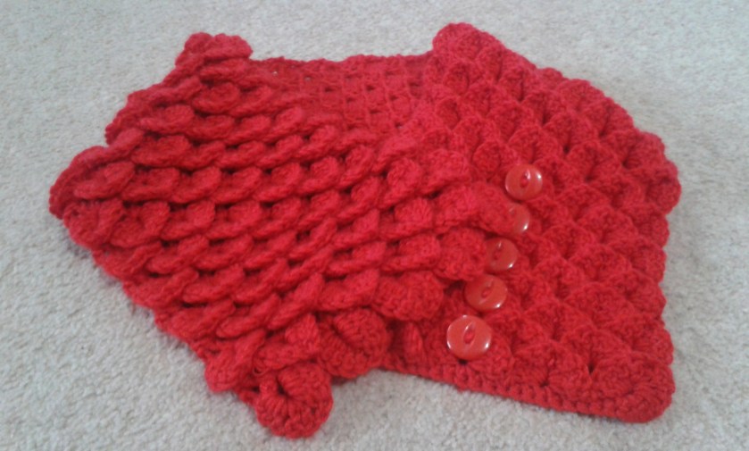 Crocodile Stitch Neck Warmer. Finished, with red buttons down the centre of one side. Can be done up either left or right-handed.